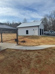 Shooting house outbuilding with covered firing position — C4 Landscaping
