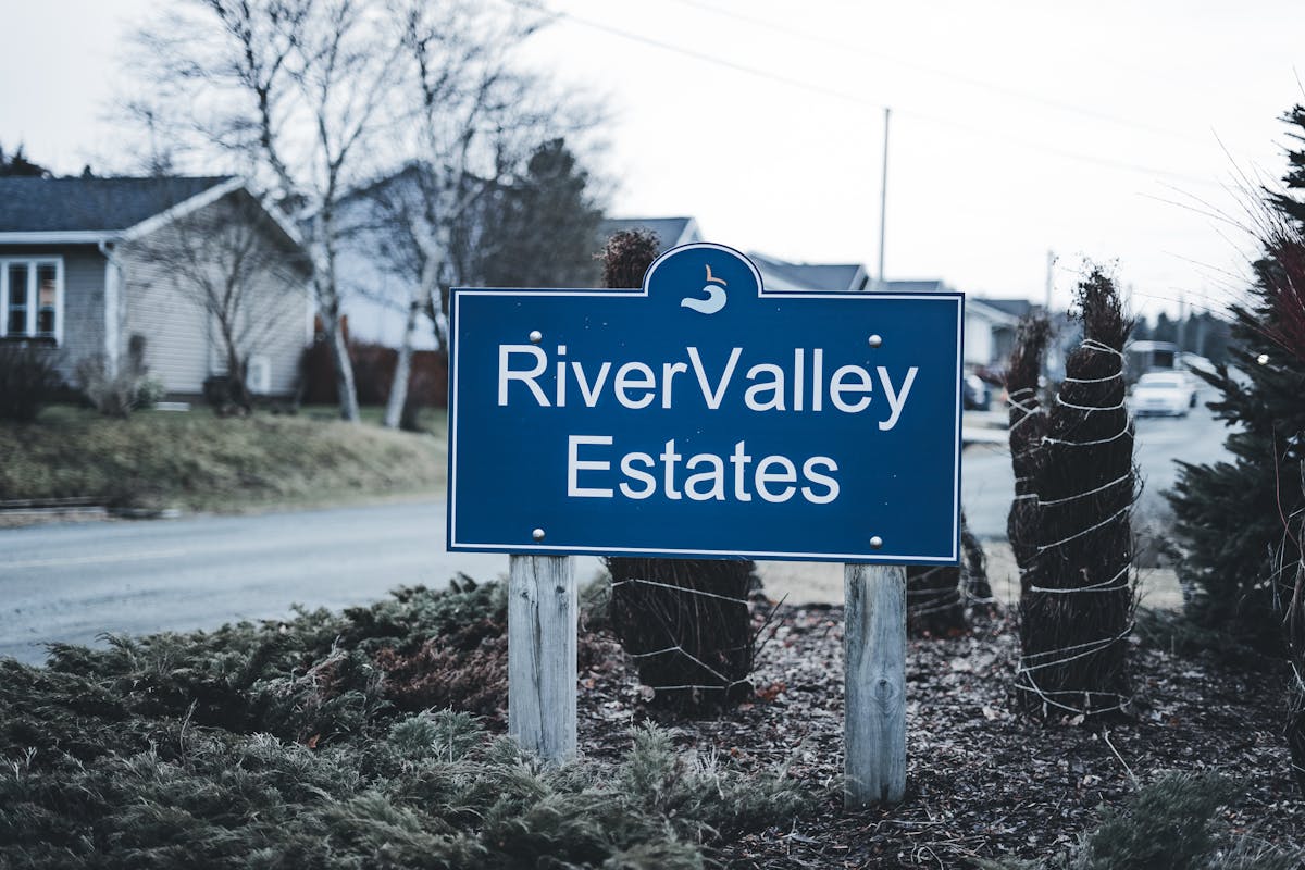 Neighborhood entrance sign with landscape bed — HOA property maintenance